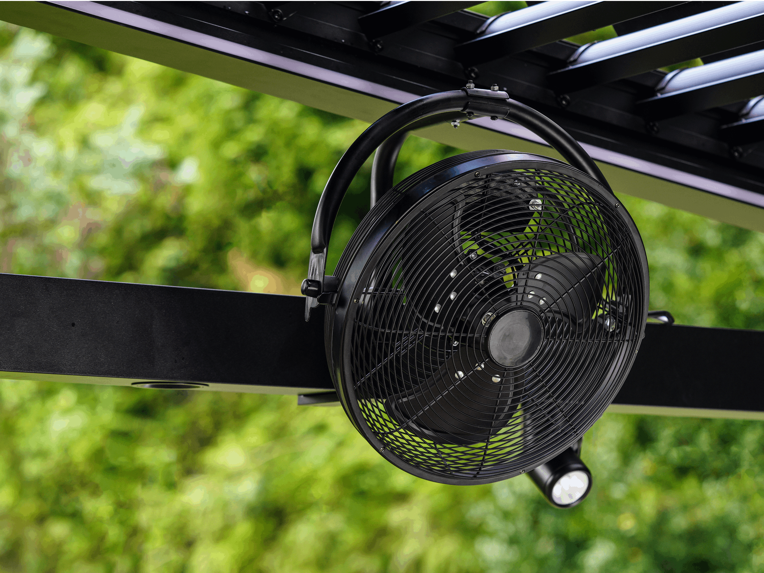 Black outdoor grill fan, mounted on pergola, designed for outdoor cooling and ventilation.