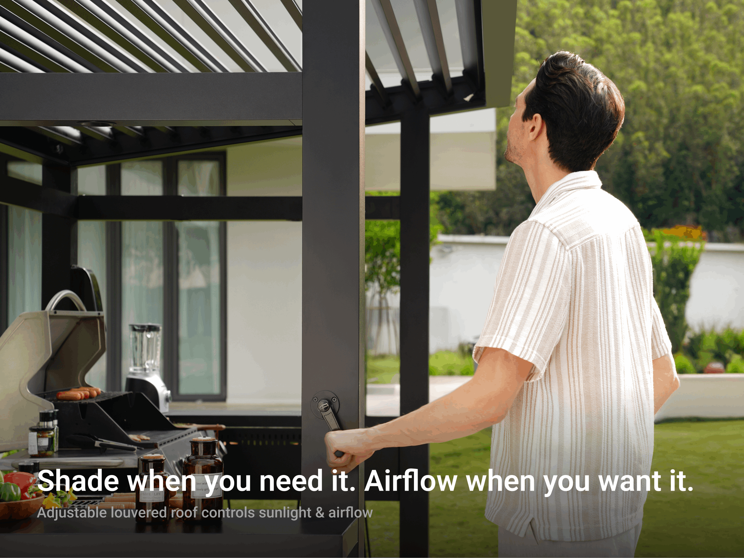 Man adjusting LuxPatio Grill Louvered Pergola Lite dark grey aluminum frame for customizable shade and airflow control.